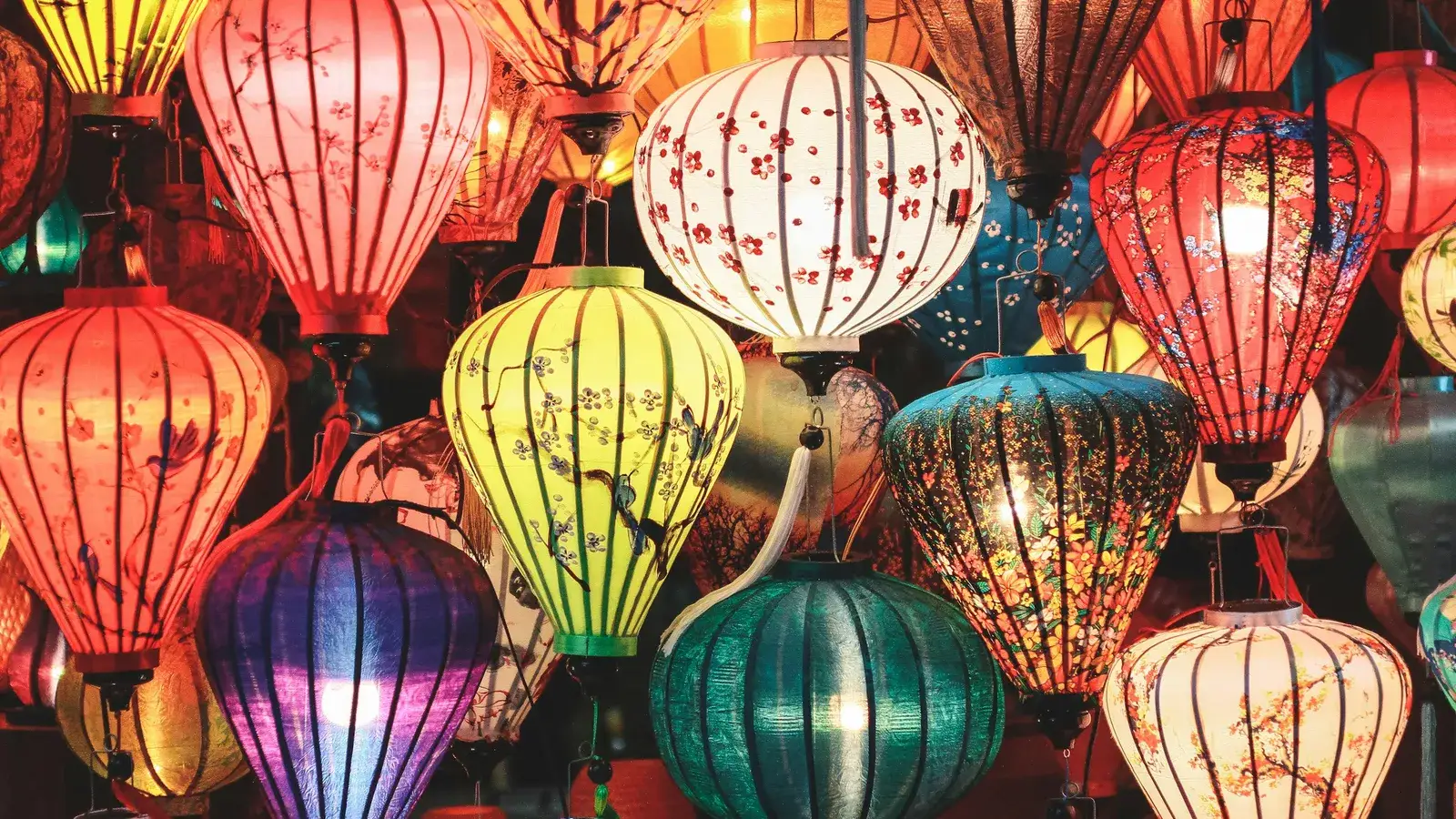 Hundreds of colourful paper lanterns glowing at a night festival