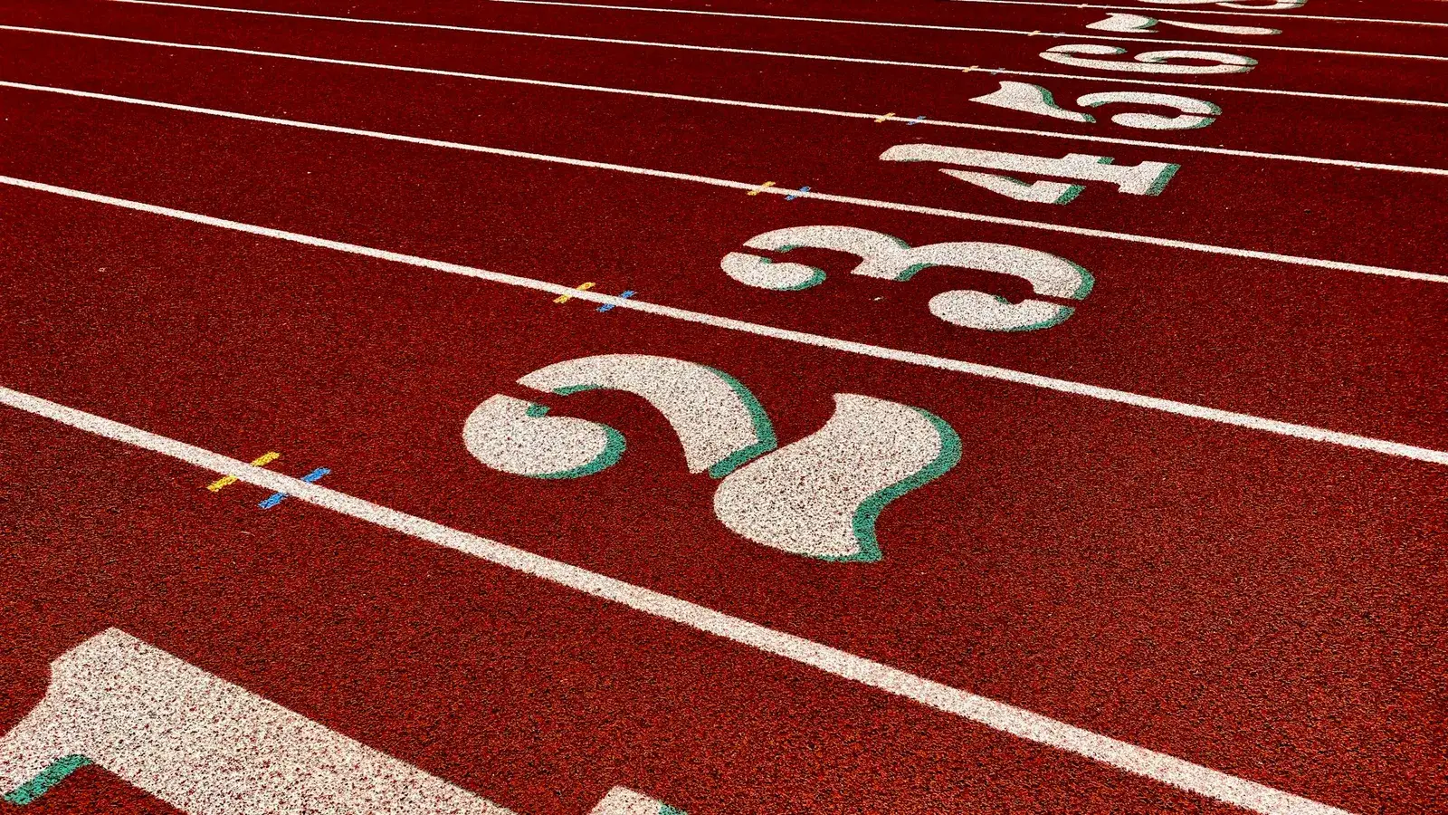 Numbered lanes at the start of a red running track